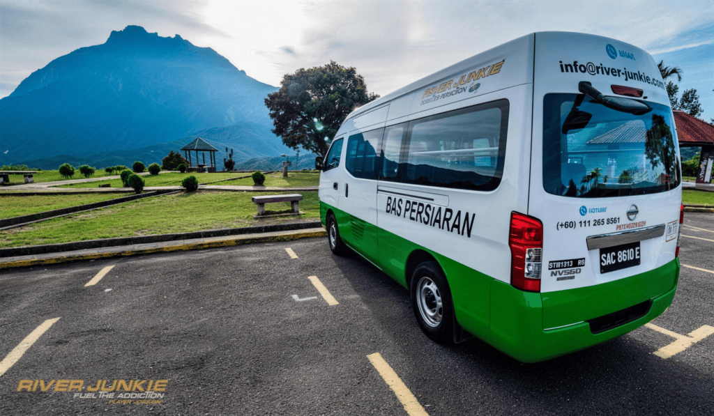 River Junkie transfer van parked with Mount Kinabalu behind